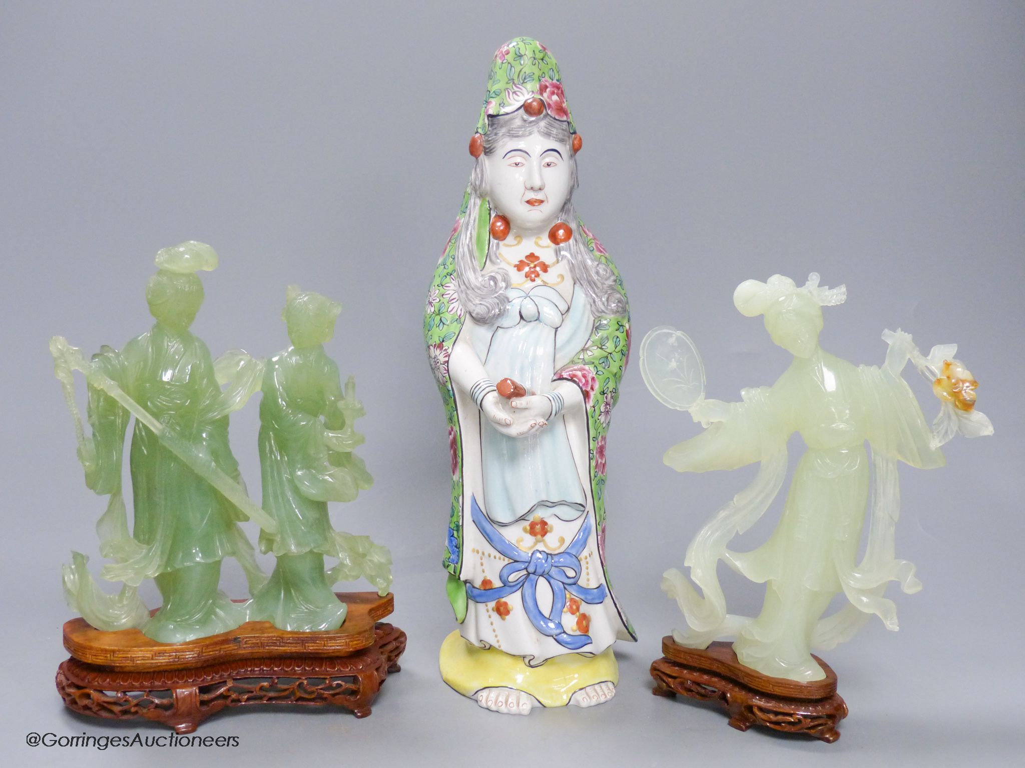 A pair of cased Chinese bowenite jade figure carvings and a porcelain figure of Guanyin, height 33cm
